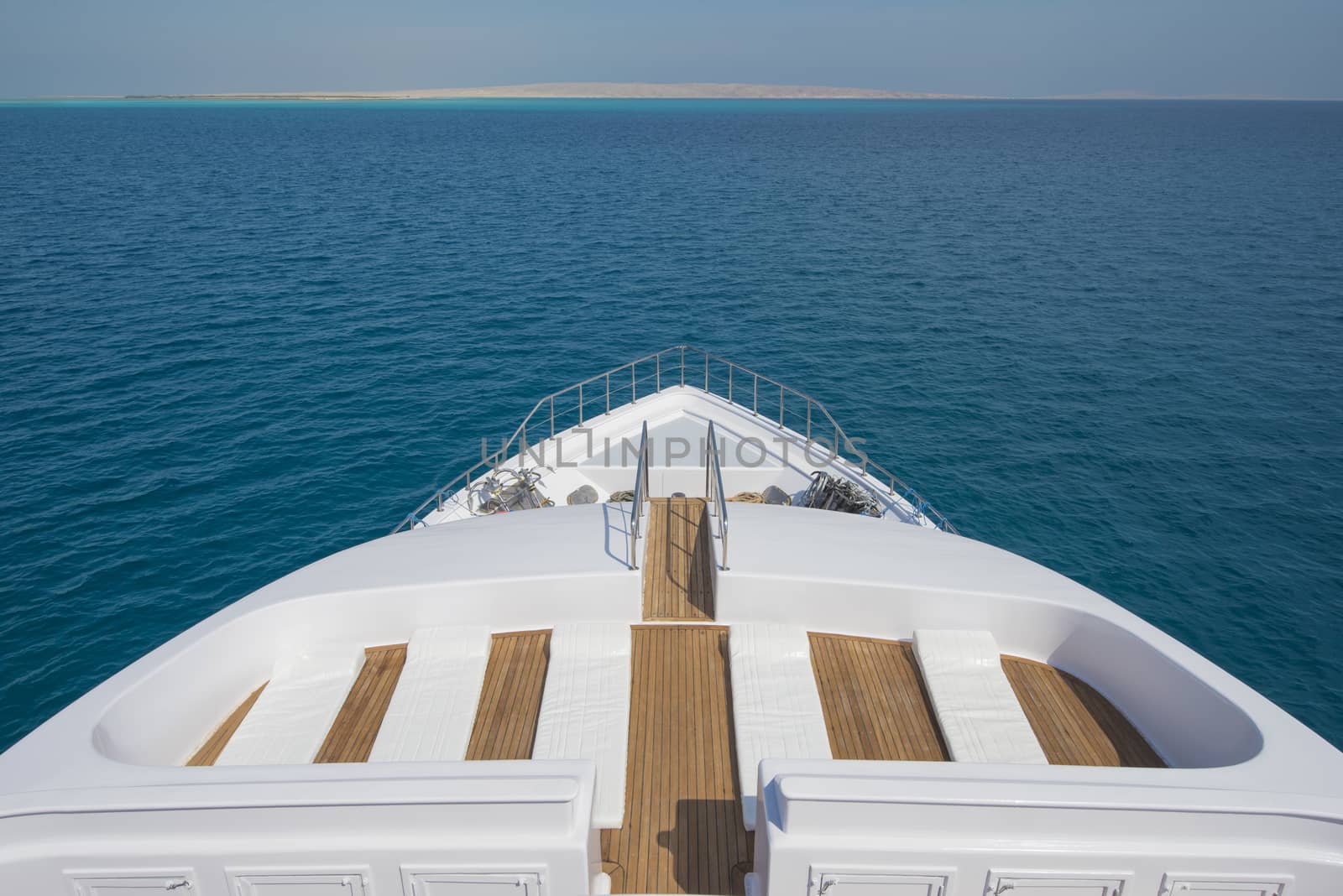 View over the bow over a large luxury motor yacht by paulvinten