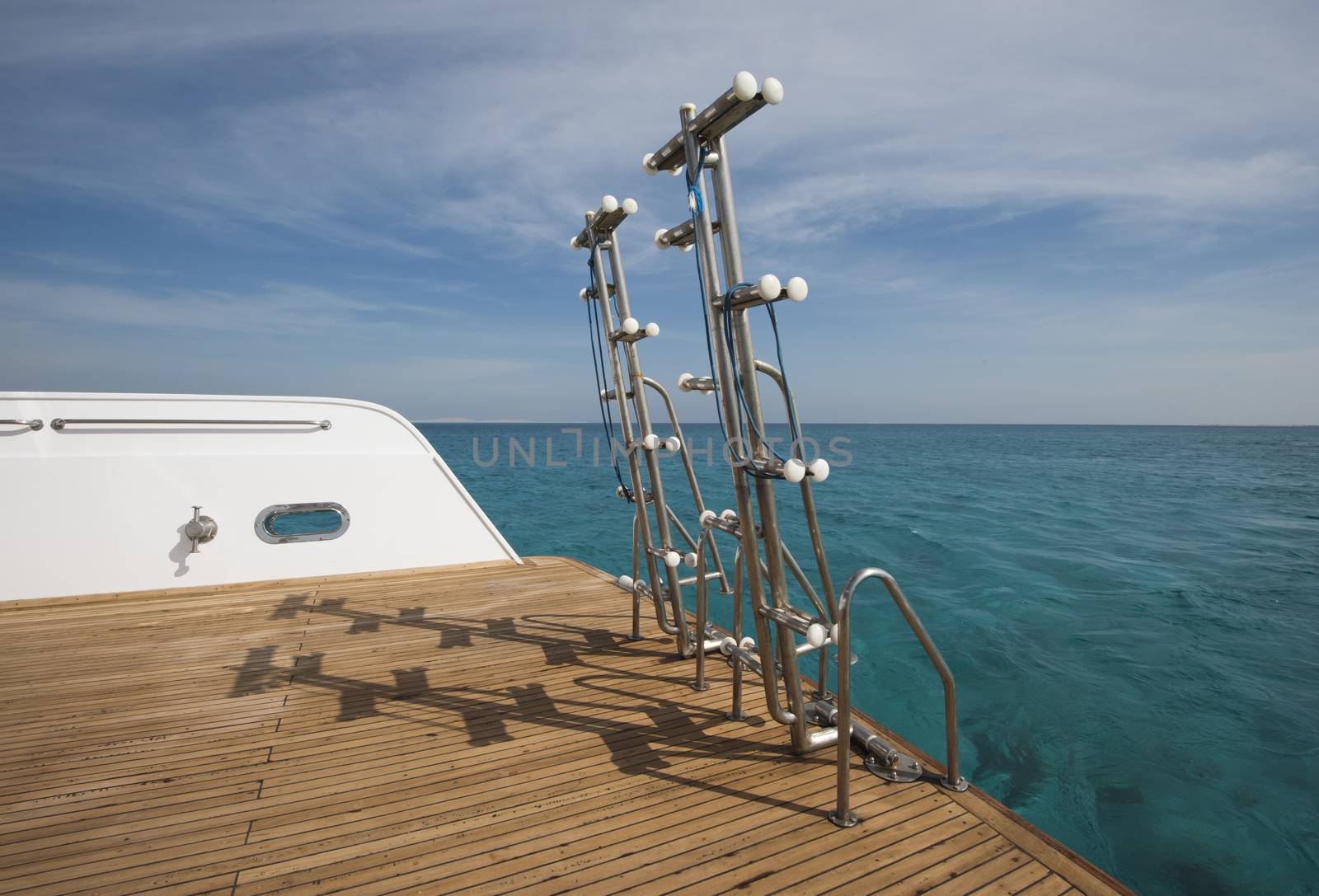 Ladders on the back of a luxury motor yacht by paulvinten