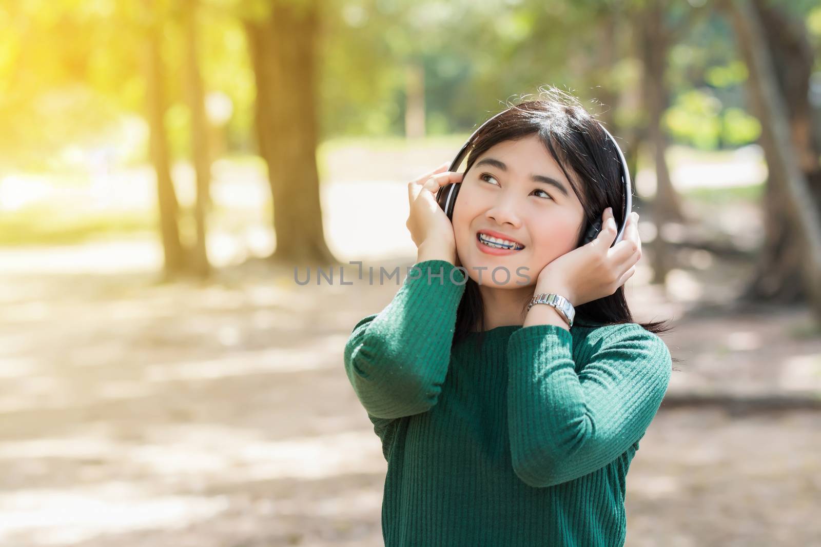 Young beautiful woman girl listening music headphones outdoor