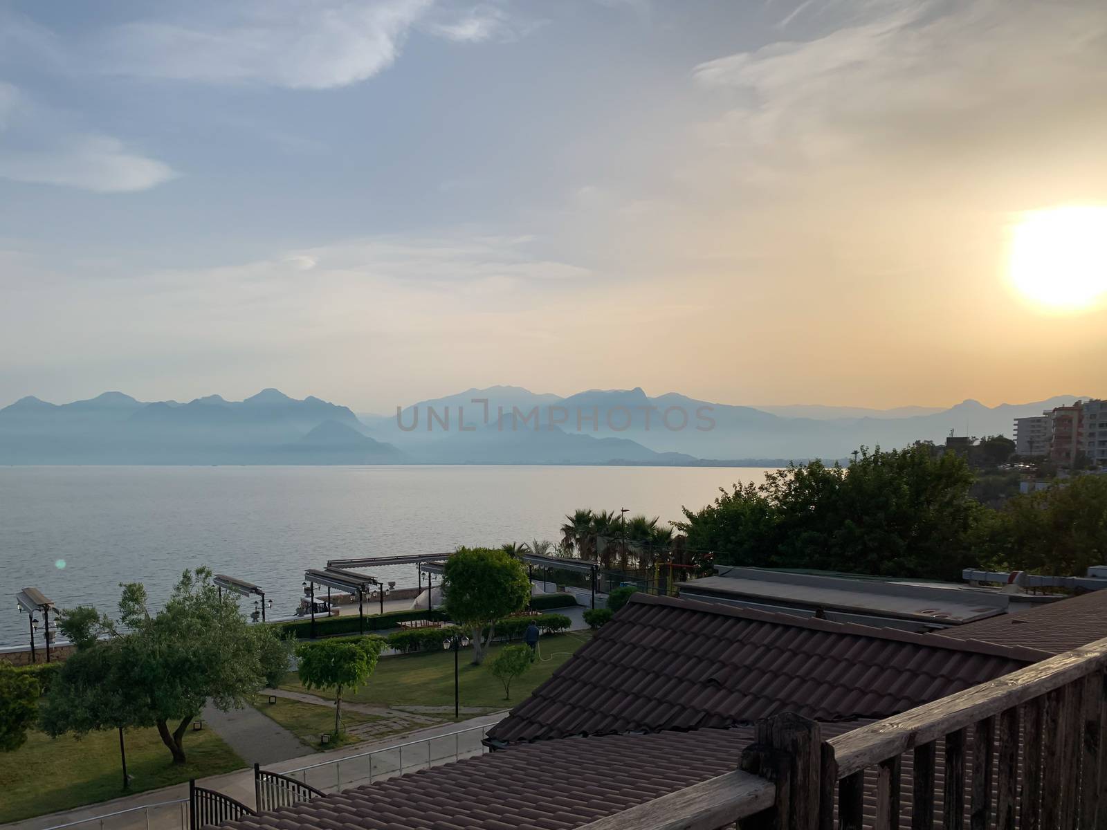 Beautiful summer sunset sunrise over Mediterranean sea with mountains silhouettes. Horizontal stock image.