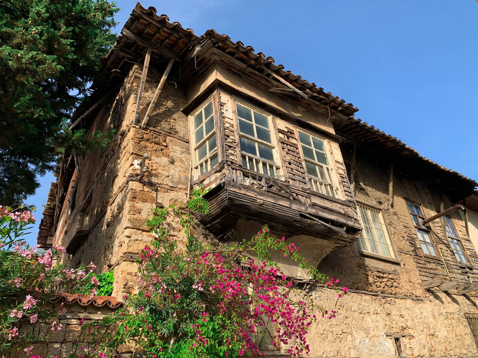 A facade of an old historical abandoned building in Antalya Old town Kaleici, Turkey. Ottoman time architecture. Horizontal stock image.