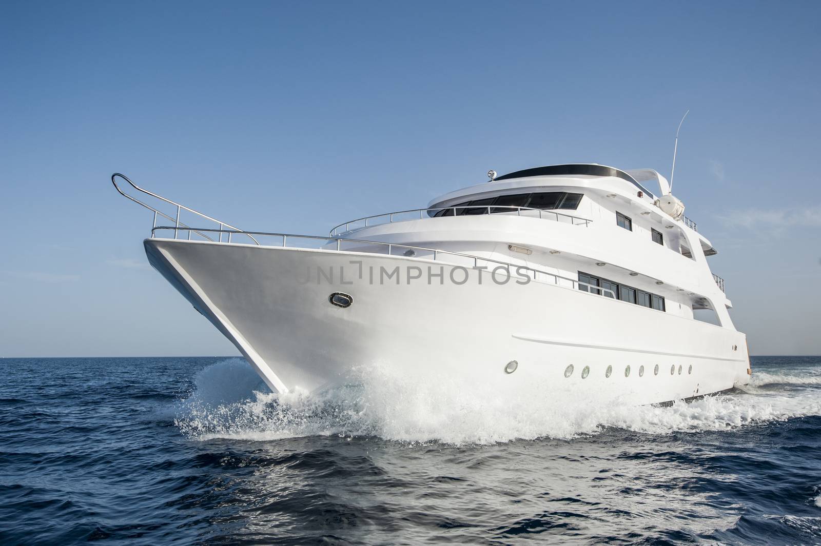 Large luxury motor yacht under way sailing out at sea