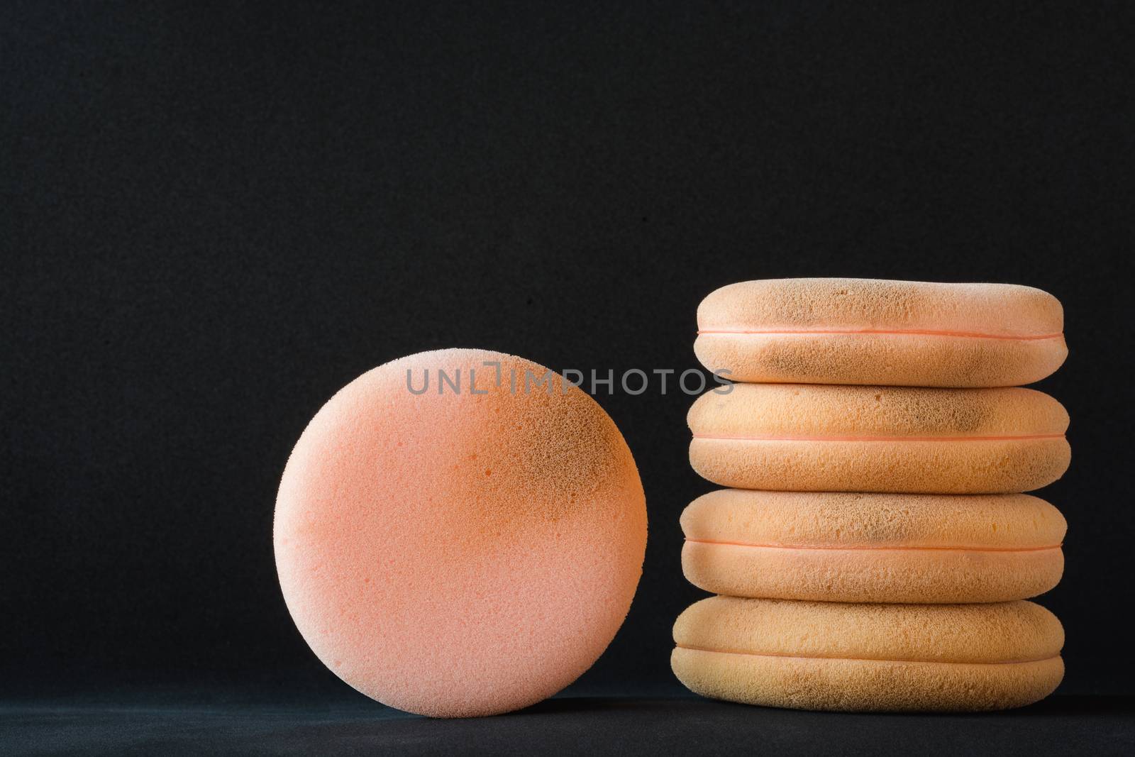 cosmetic sponges used on black background