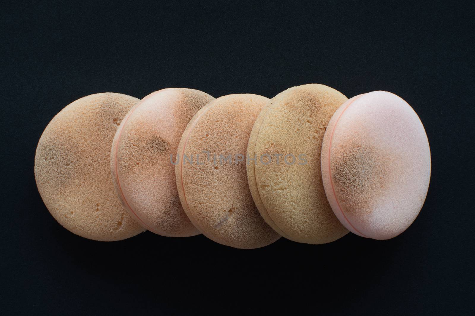 cosmetic sponges used on black background