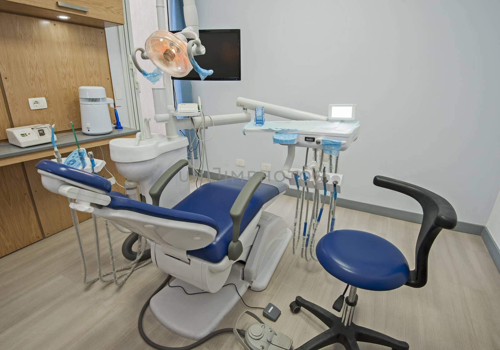 Interior of dentist surgery clinic with chair by paulvinten