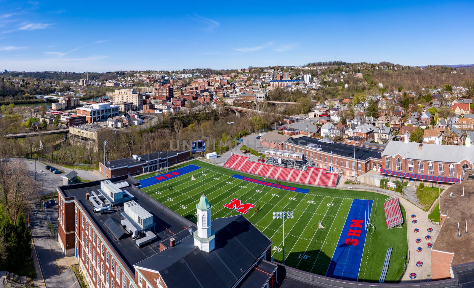 Morgantown, WV - 6 April 2020: Aerial drone view of the downtown area of Morgantown West Virginia with high school football field in the foreground