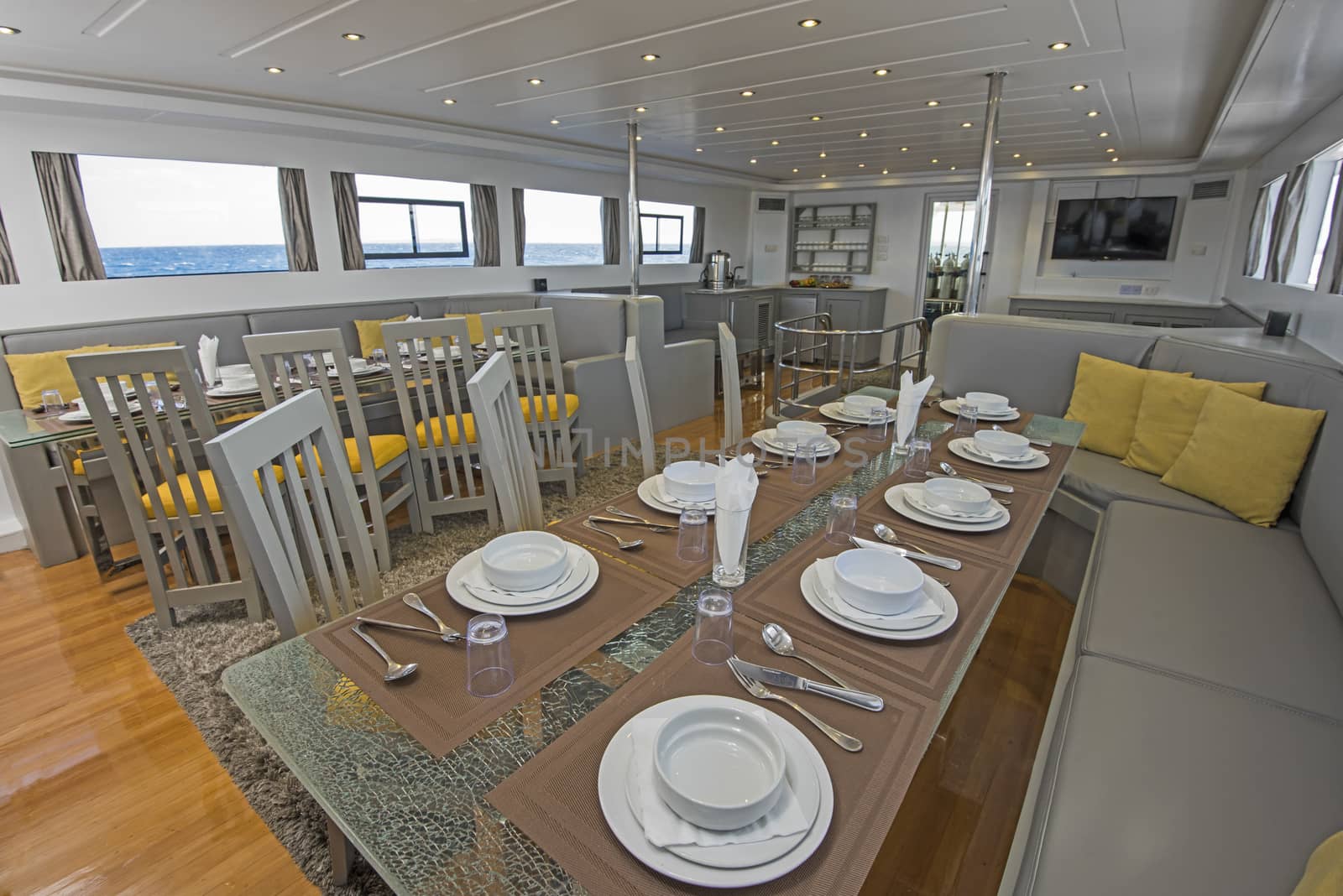 Interior of large salon dining area of luxury motor yacht by paulvinten