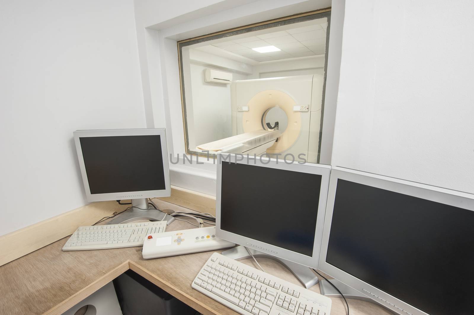Hi-tech medical equipment CT scanner in hospital medical clinic center with control room