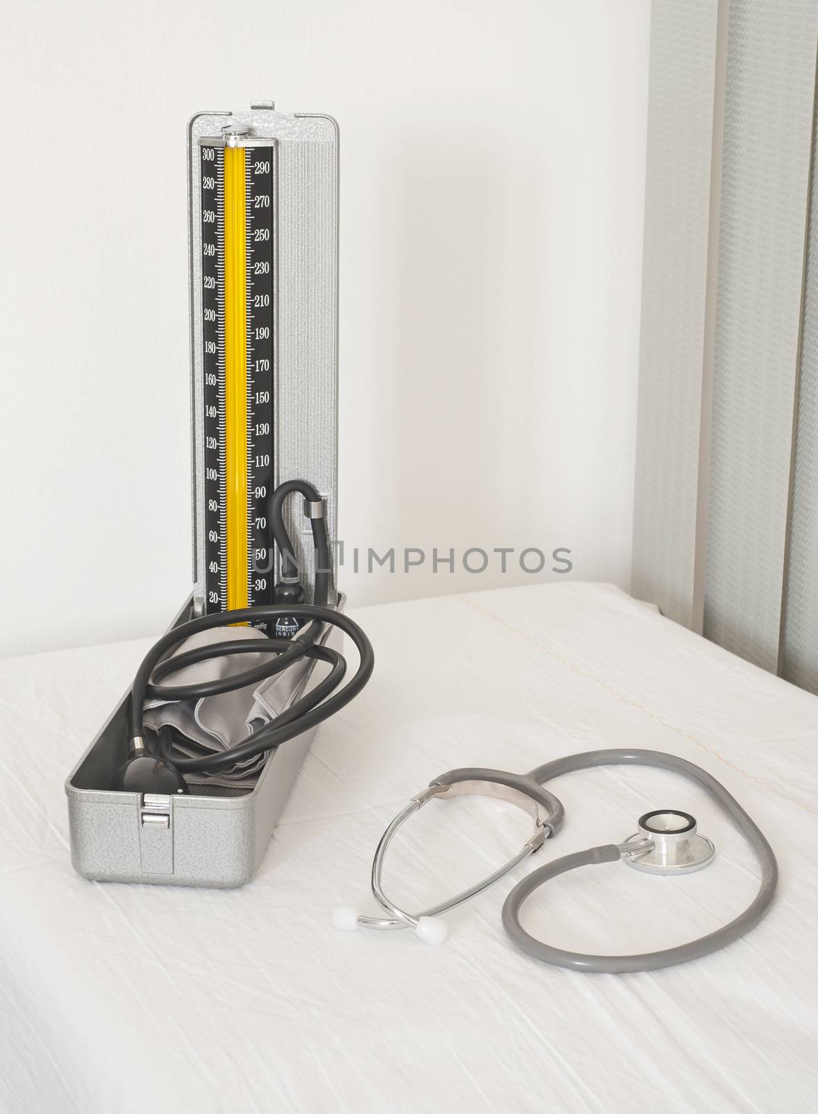 Medical blood pressure gauge and doctors stethoscope on a white background