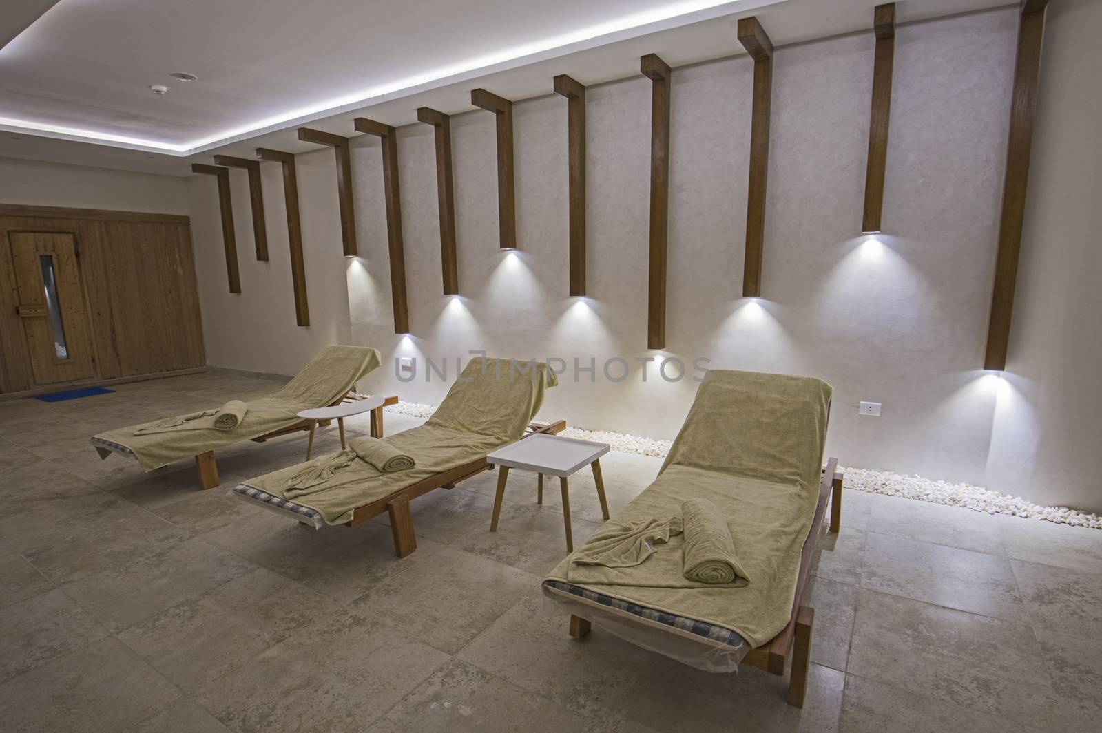 Relaxation area inside a luxury health spa with beds and towels