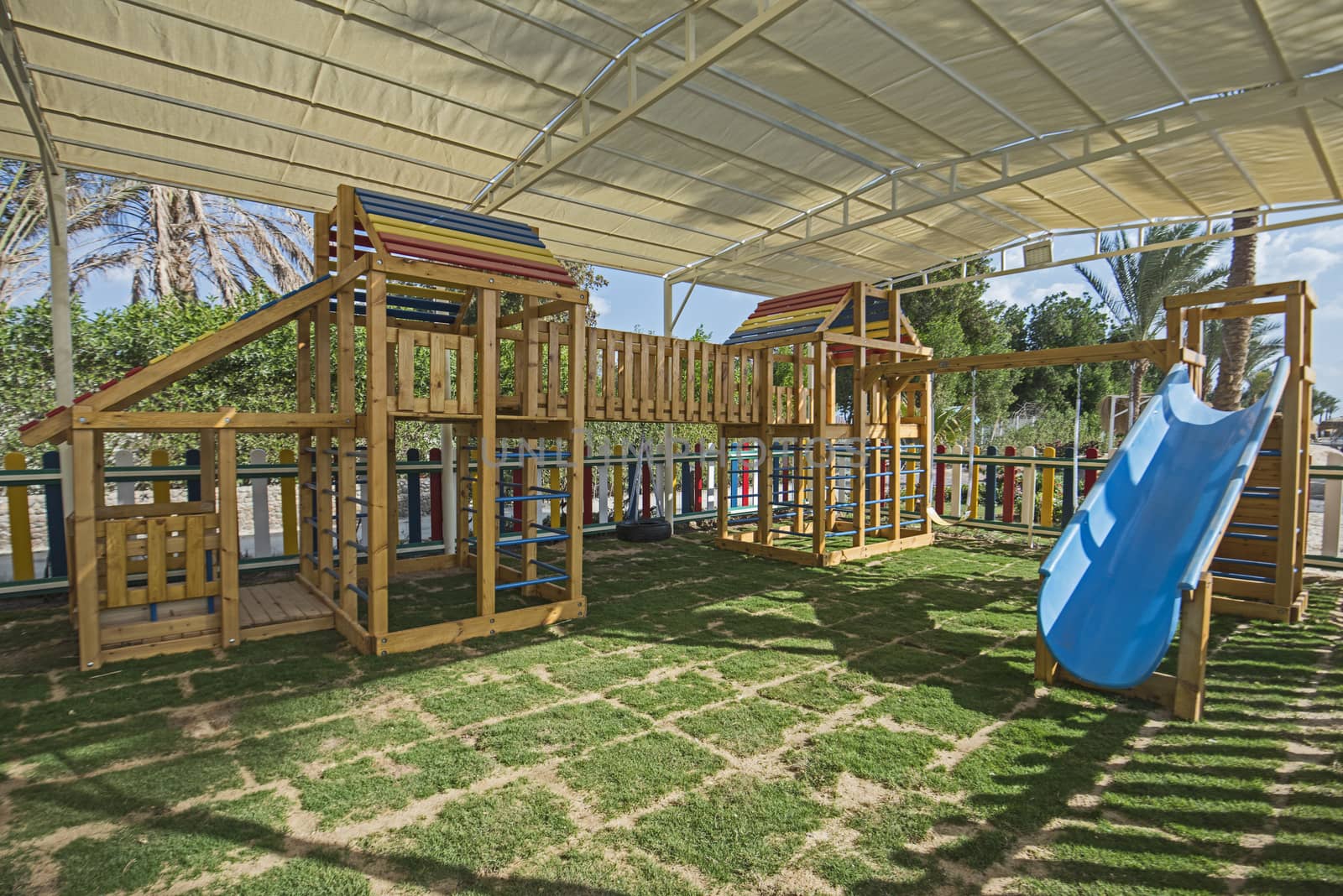 Large wooden climbing frame structure in children's playground area of luxury hotel
