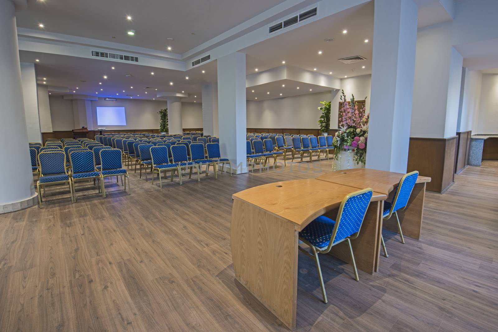 Interior design of large conference meeting room in luxury hotel with rows of chairs
