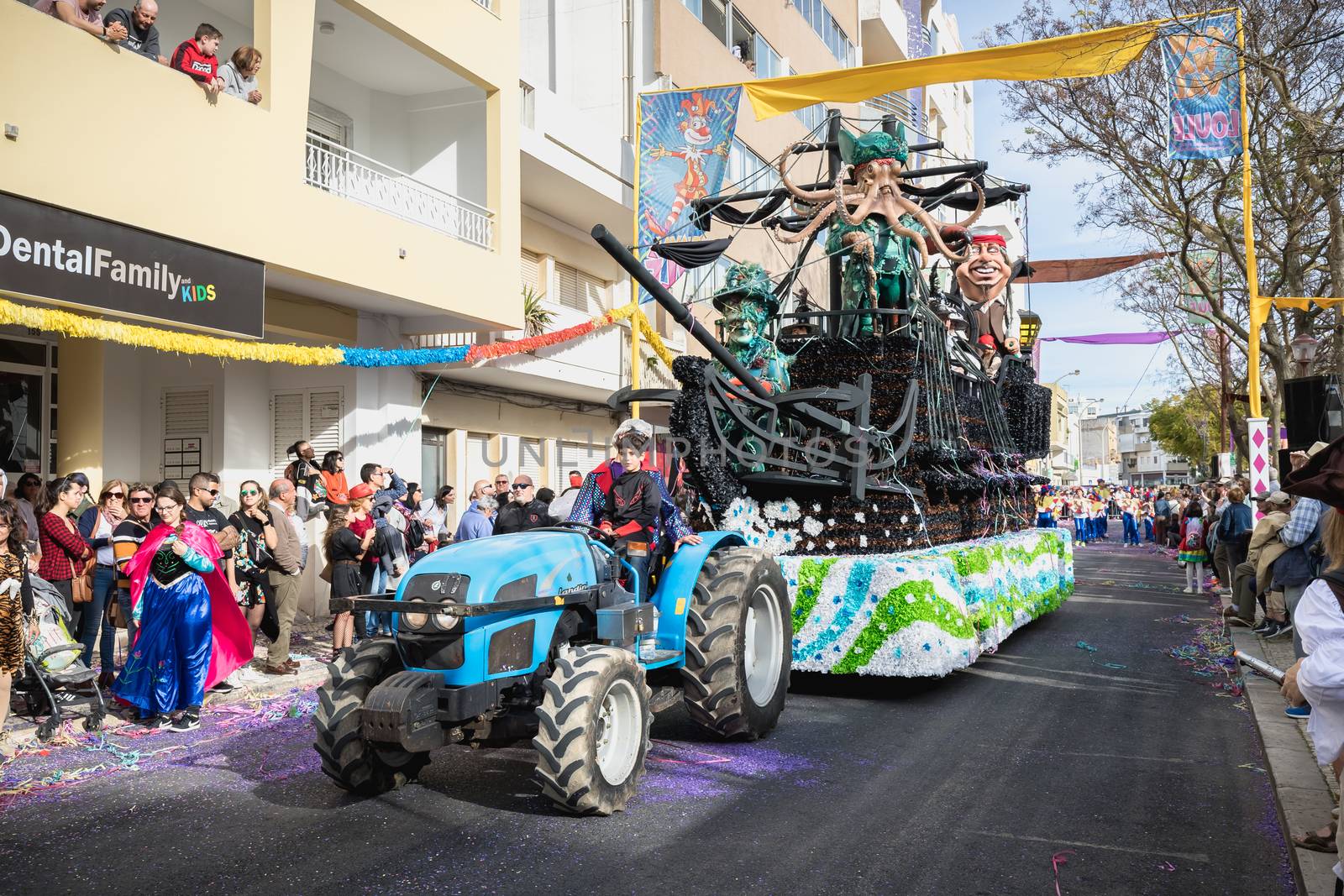 Loule, Portugal - February 25, 2020: Pirate ship float parading in the street in front of the public in the parade of the traditional carnival of Loule city on a February day