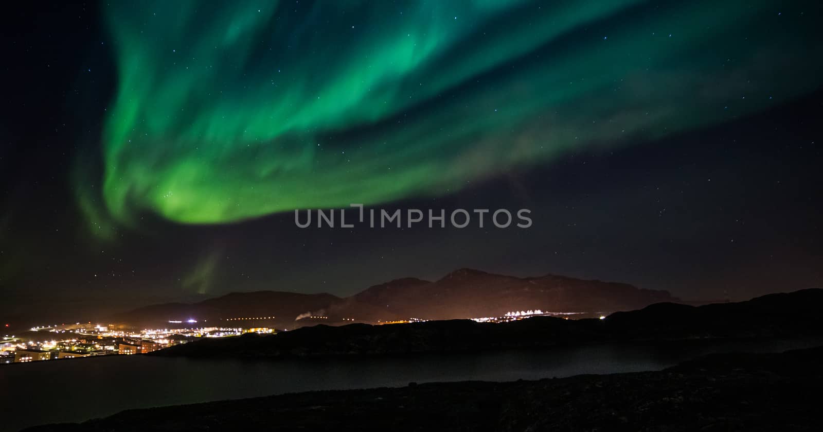 Massive green Northern lights shining over Nuuk city, Greenland