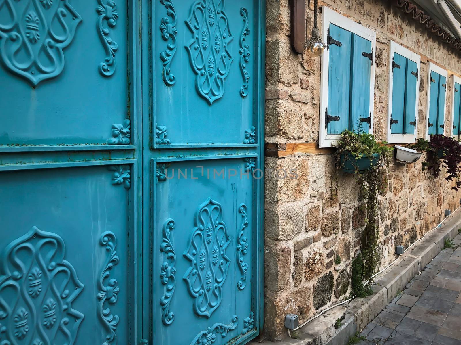Turquoise gate and shutters of an old house in old town of Antalya Kaleici