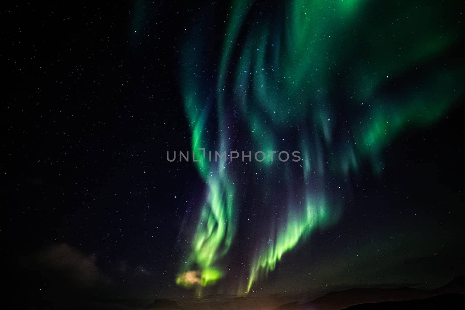 Massive green Aurora Borealis Northern lights shining over the l by ambeon