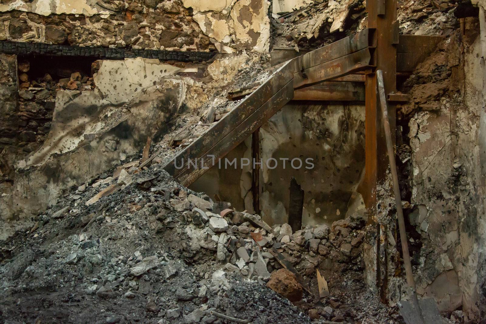 Ruins of burned ancient historical 2 floors house after fire disaster accident in old town of Antalya Kaleici Turkey. Stock image of heaps of ash and arson, collapsed roof and broken windows.