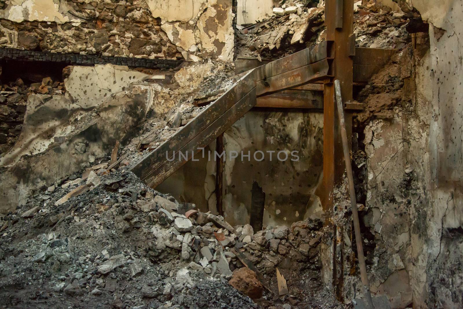 Ruins of burned ancient historical 2 floors house after fire disaster accident in old town of Antalya Kaleici Turkey. Stock image of heaps of ash and arson, collapsed roof and broken windows.