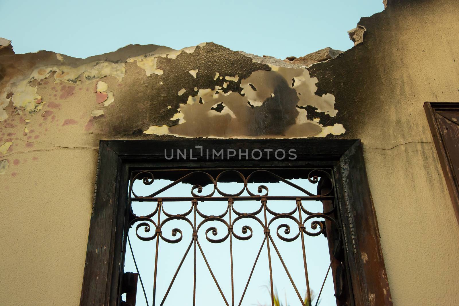 Ruins of burned ancient historical 2 floors house after fire disaster accident in old town of Antalya Kaleici Turkey. Stock image of heaps of ash and arson, collapsed roof and broken windows.