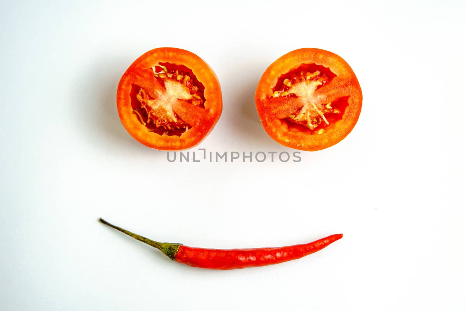 Tomatoes and red peppers smiling in a good mood white background