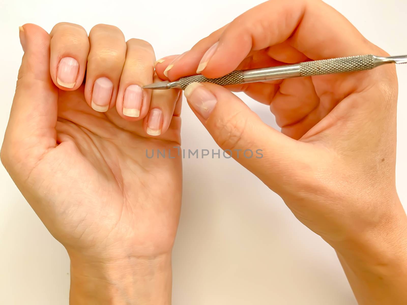 Female woman doing manicure at home on a white background by AlonaGryadovaya