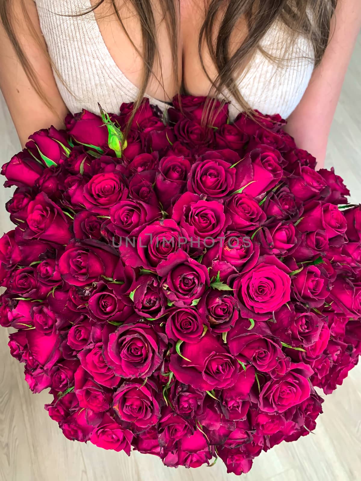 A young girl holding in hands a huge bouquet of 101 wonderful pu by AlonaGryadovaya