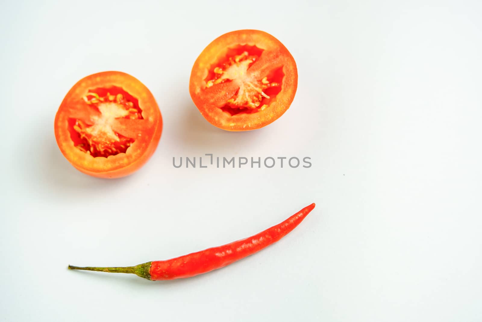 Tomatoes and red peppers smiling in a good mood white background
