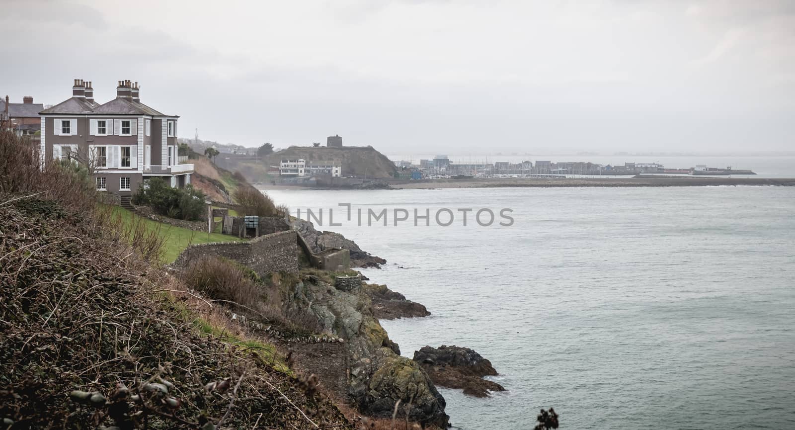 Howth, Ireland - February 15, 2019: Distant view of a small touristy fishing port near Dublin on a winter day