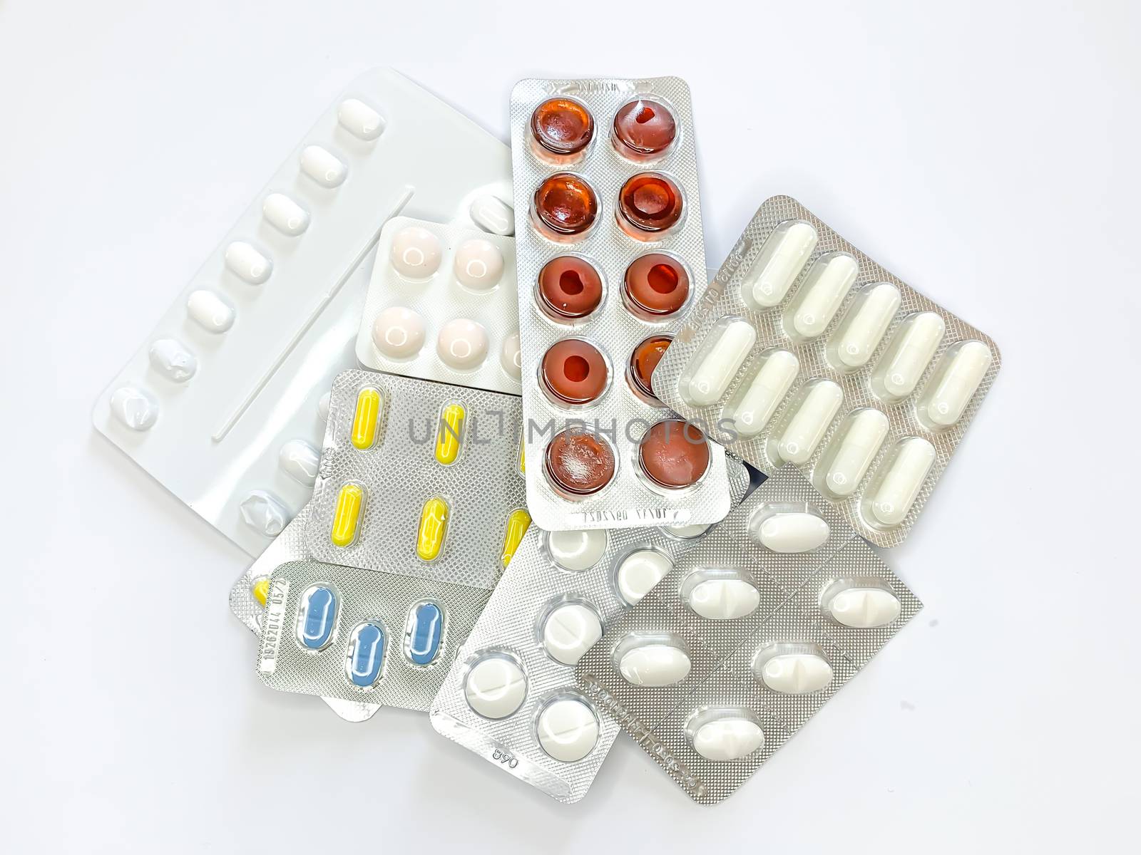 Many plenty a lot of tablets in blister pack, pills, capsules on a white background. Horizontal image