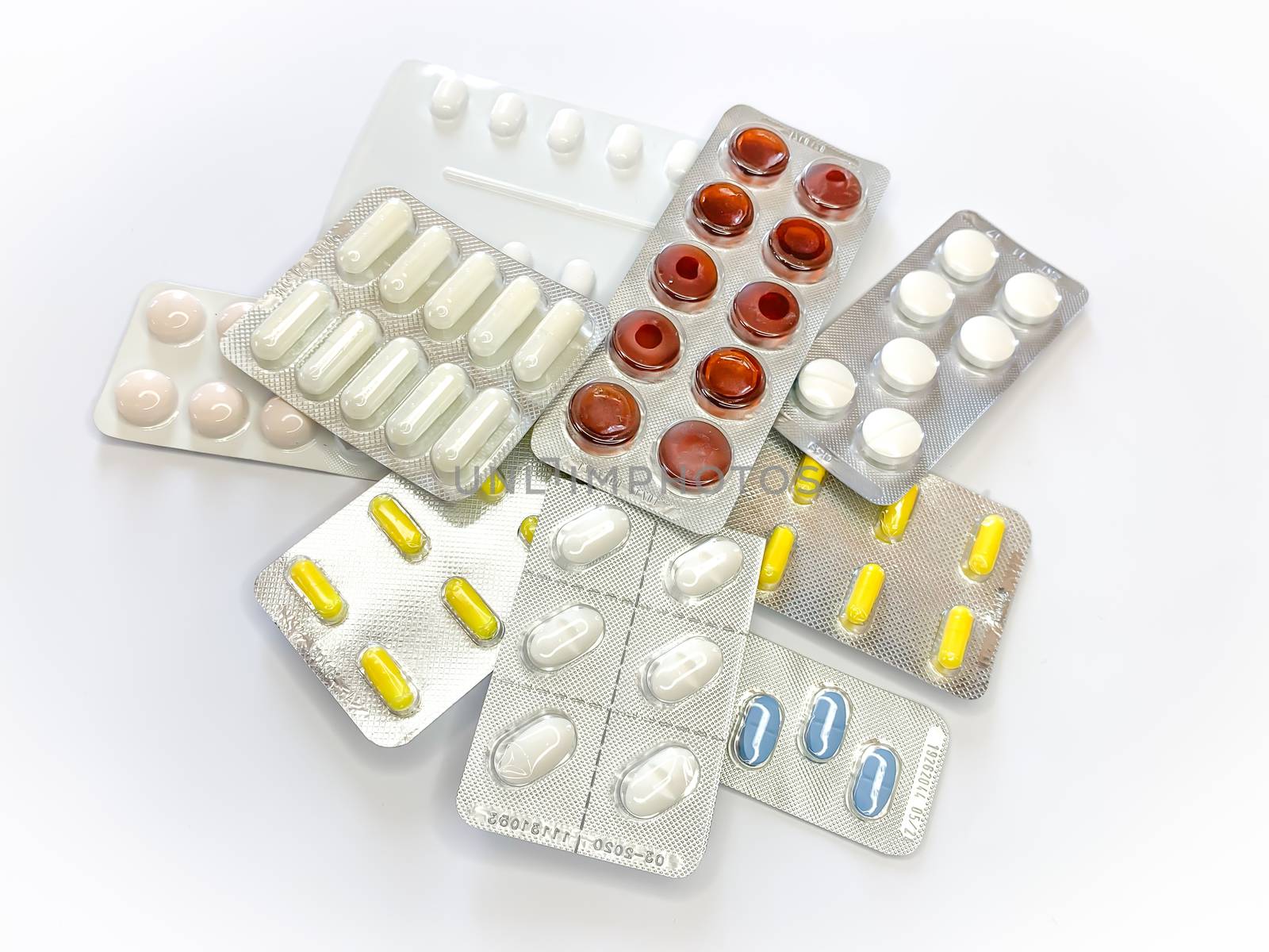 Many plenty a lot of tablets in blister pack, pills, capsules on a white background. Horizontal image