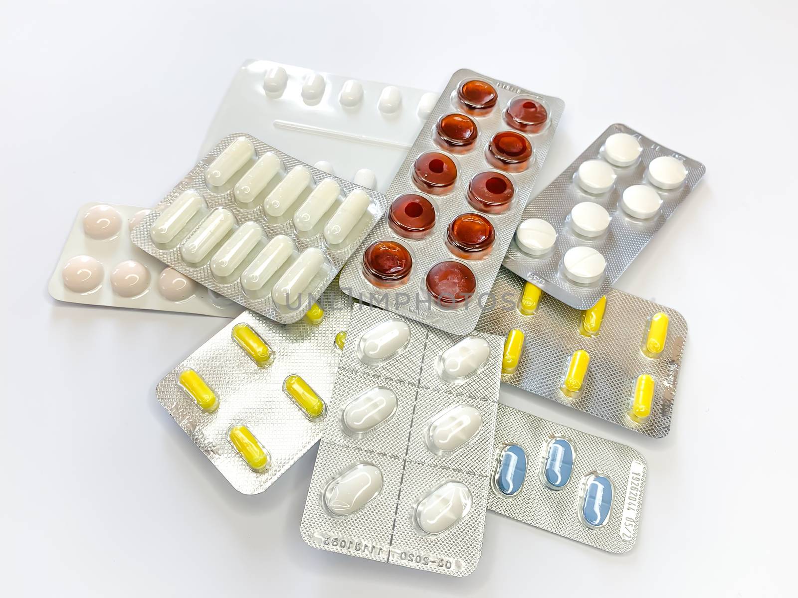 Many plenty a lot of tablets in blister pack, pills, capsules on a white background. Horizontal image
