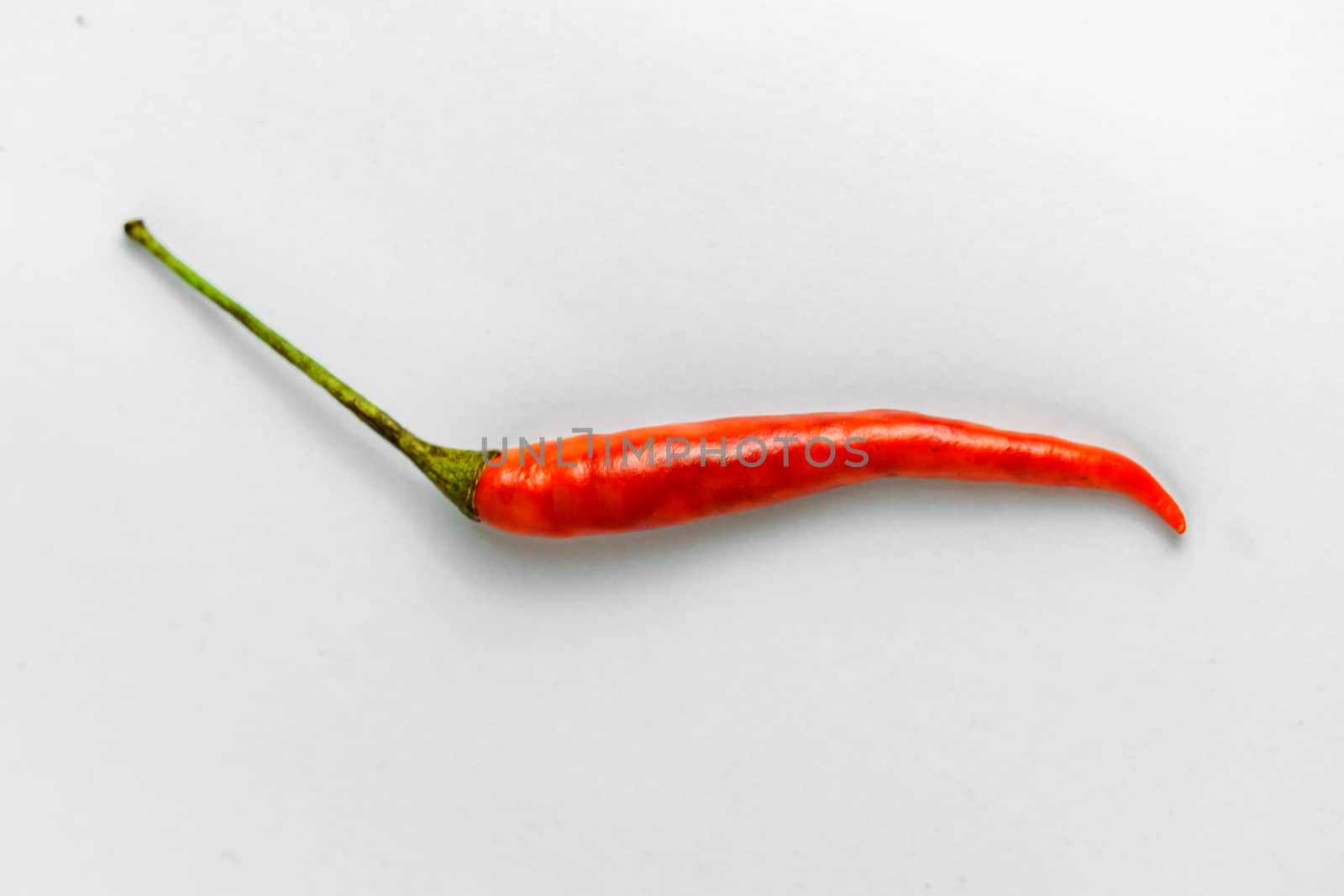 Close-up shot of red peppers on a white background. Fresh food ingredients concept.