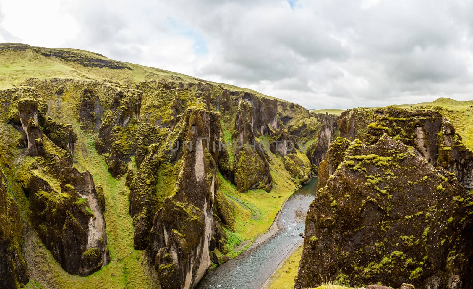 Fjadrargljufur canyon steep cliffs and waters of Fjadra river panorama, South Iceland