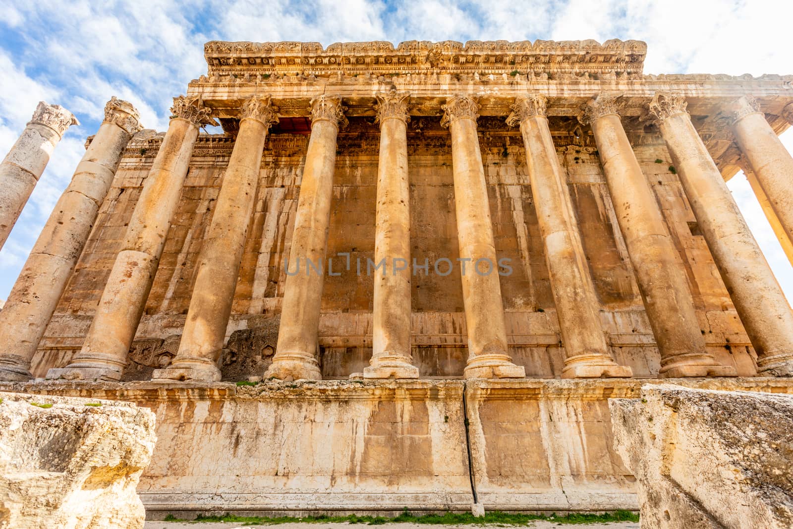 Columns of ancient Roman temple of Bacchus and blue sky in the b by ambeon