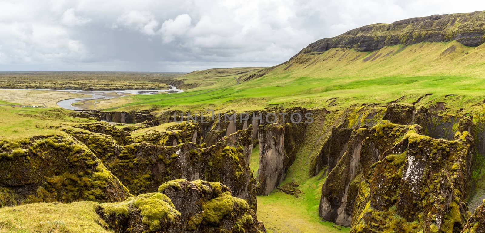 Fjadrargljufur canyon steep cliffs and waters of Fjadra river panorama, South Iceland