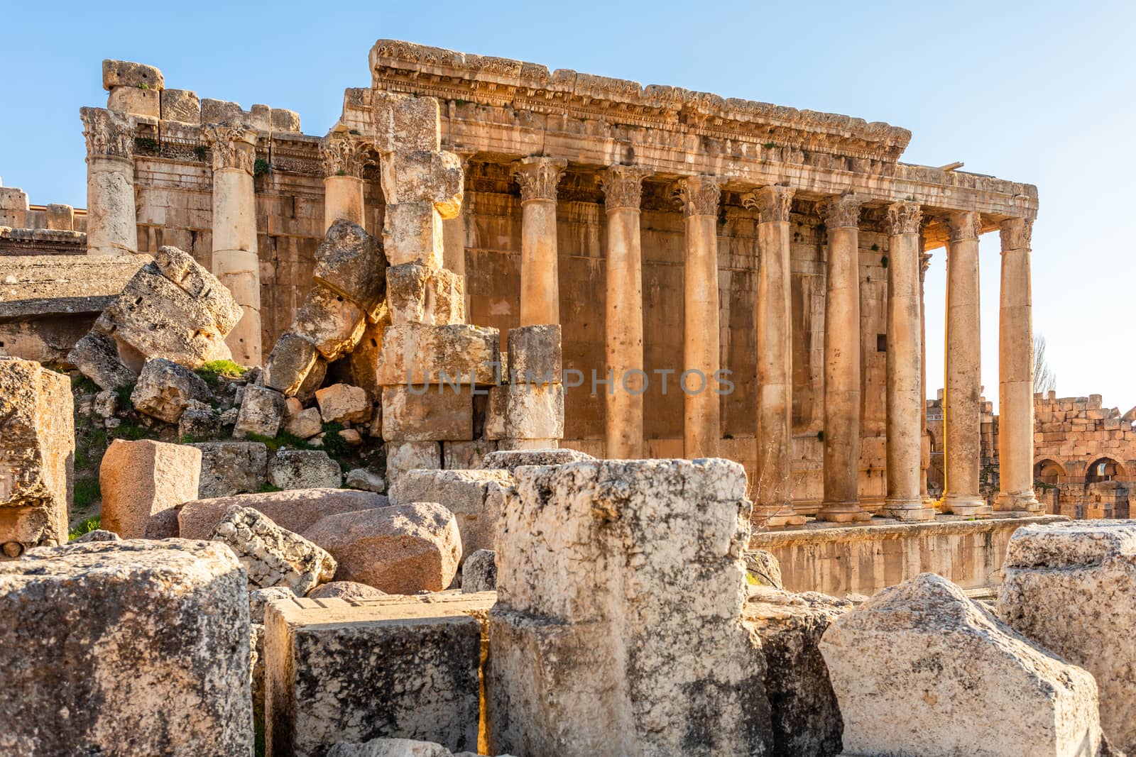 Columns of ancient Roman temple of Bacchus with surrounding ruin by ambeon