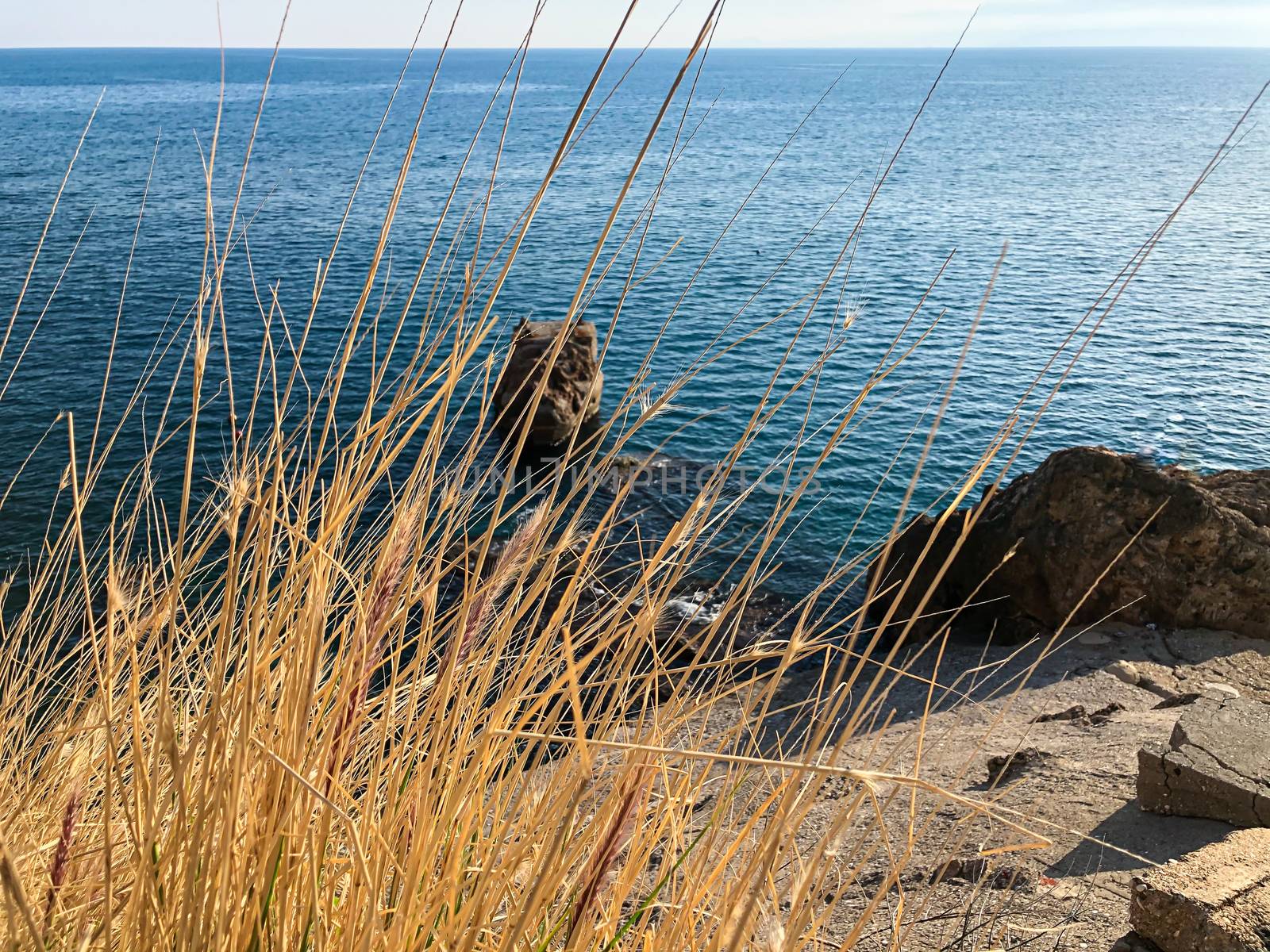 Rocks in Mediterranean sea shore on a shiny day