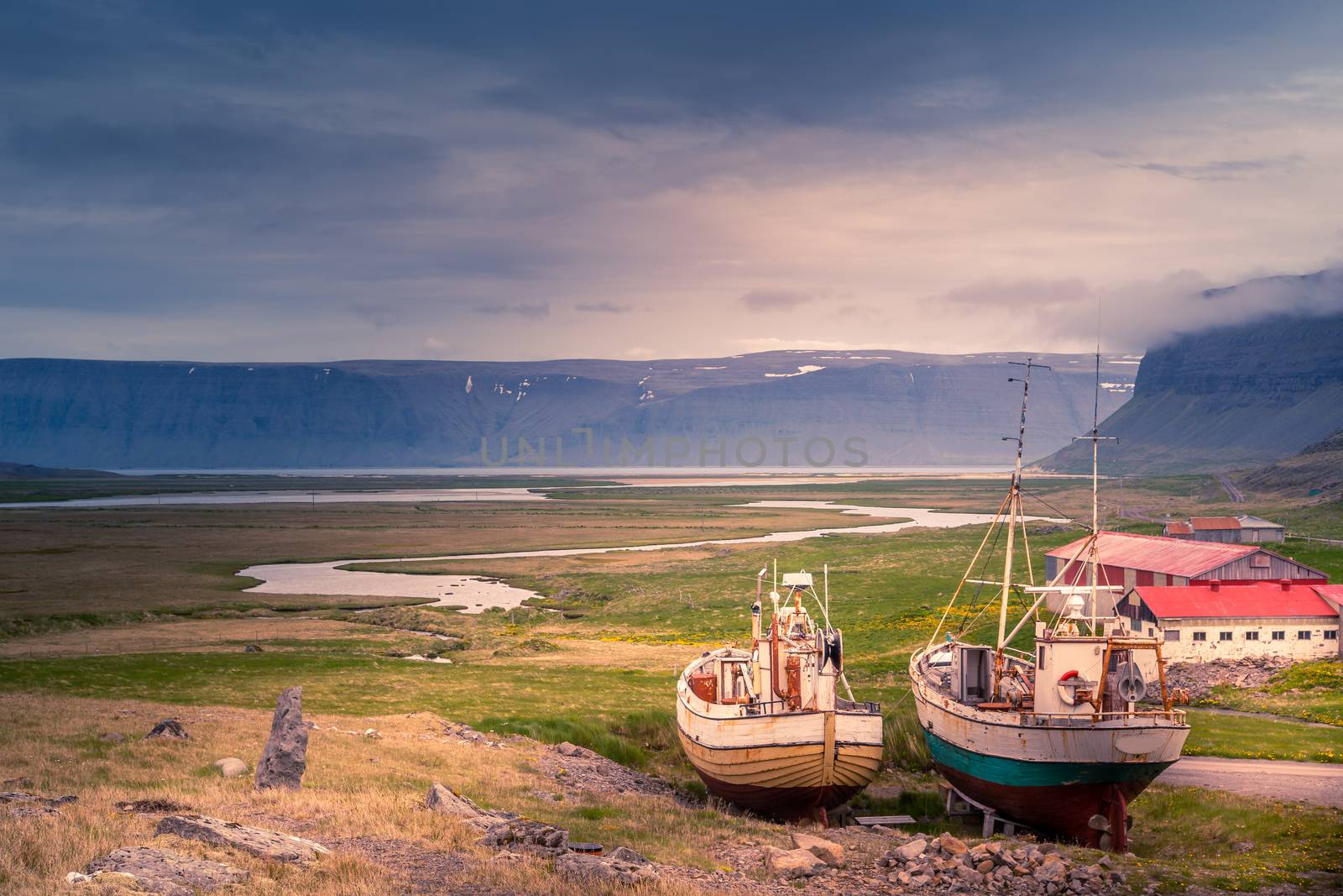 Old fishing ships standing ashore at , West Fjords, Iceland by ambeon