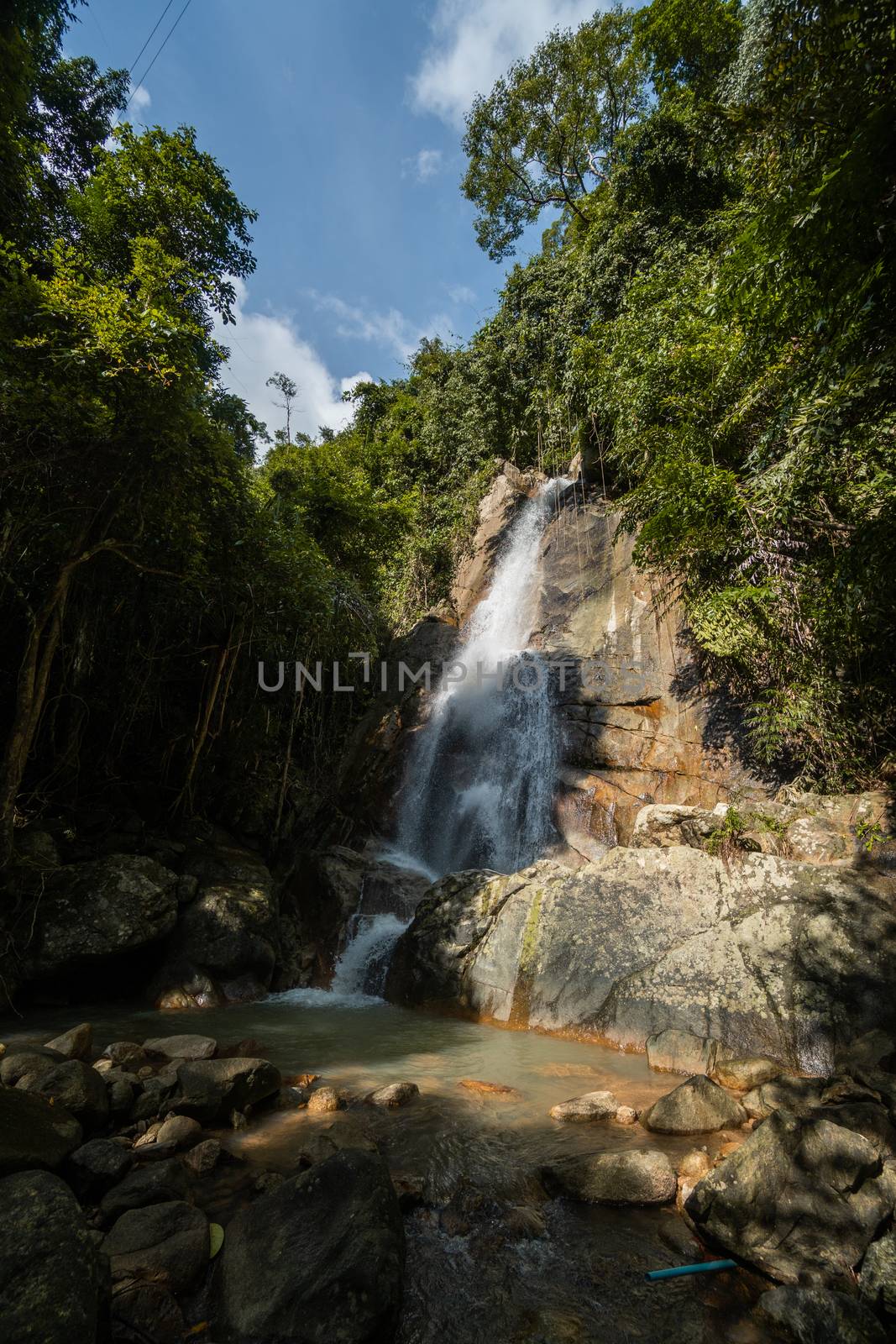 Secret tropical waterfall in jungle on a Samui island