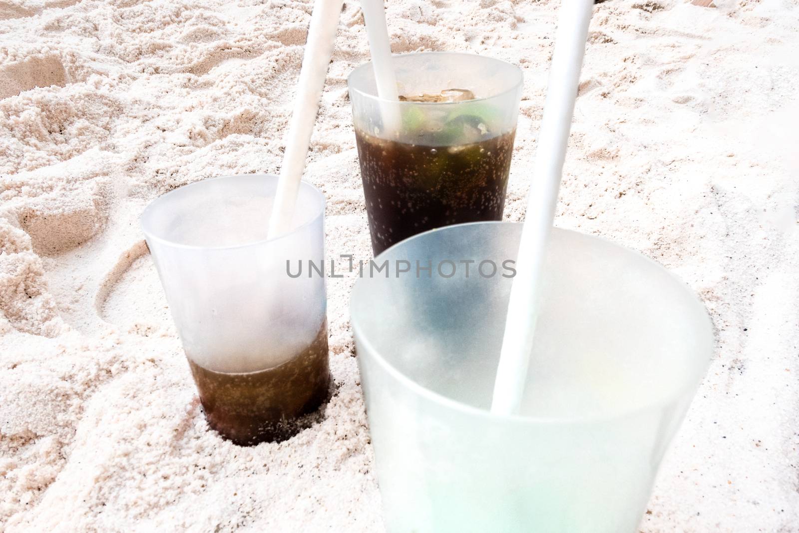 Plastic cups on the beach by Guinness