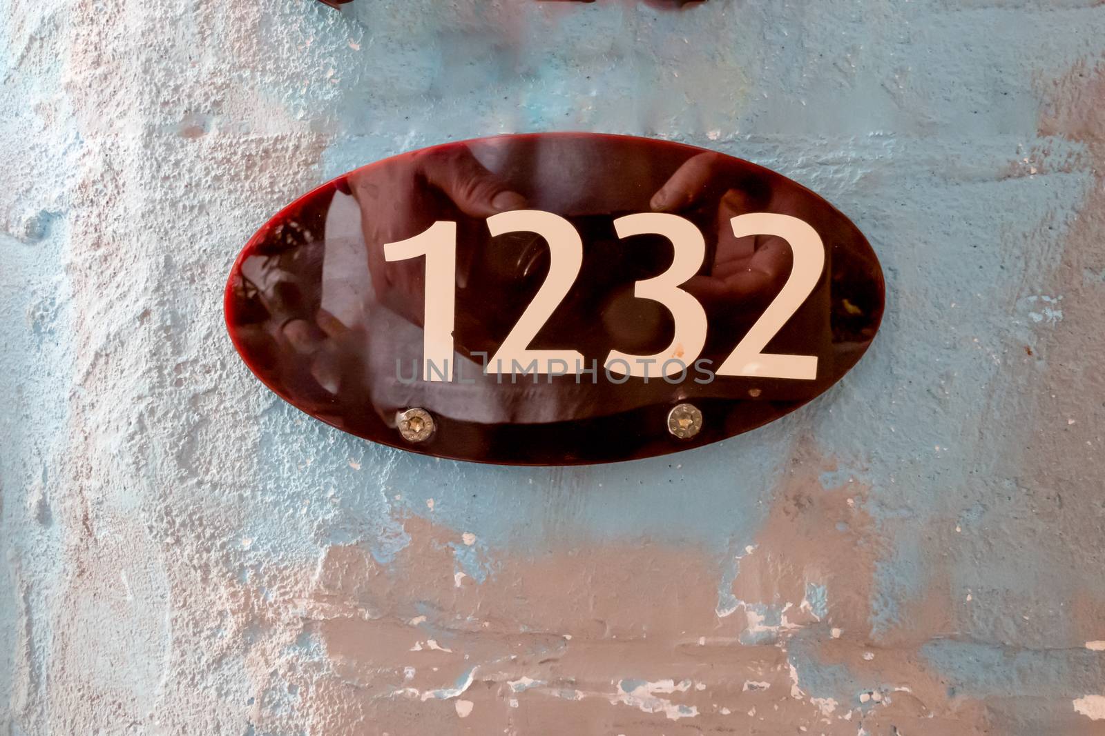 Oval sign with the number 1232 by Guinness