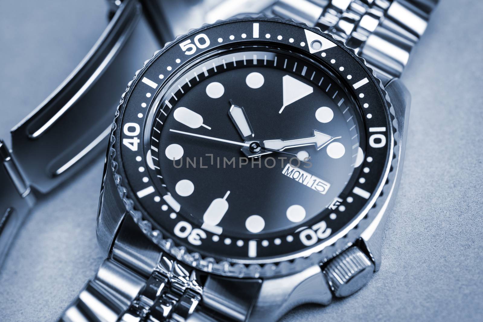 Close up men dive watch with stainless steel bracelet, luxury wristwatch for men.