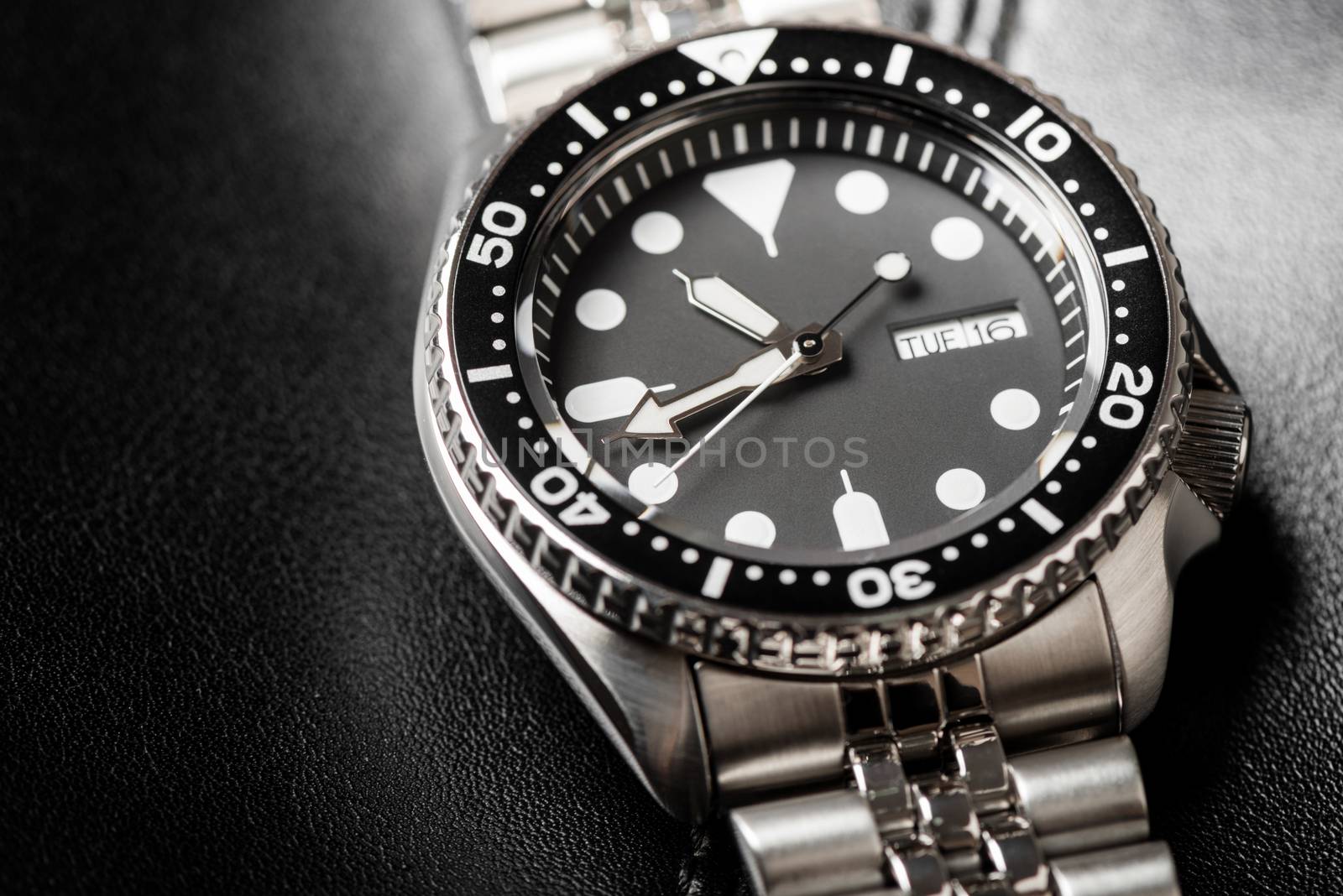 Close up men dive watch with stainless steel bracelet, luxury wristwatch for men.