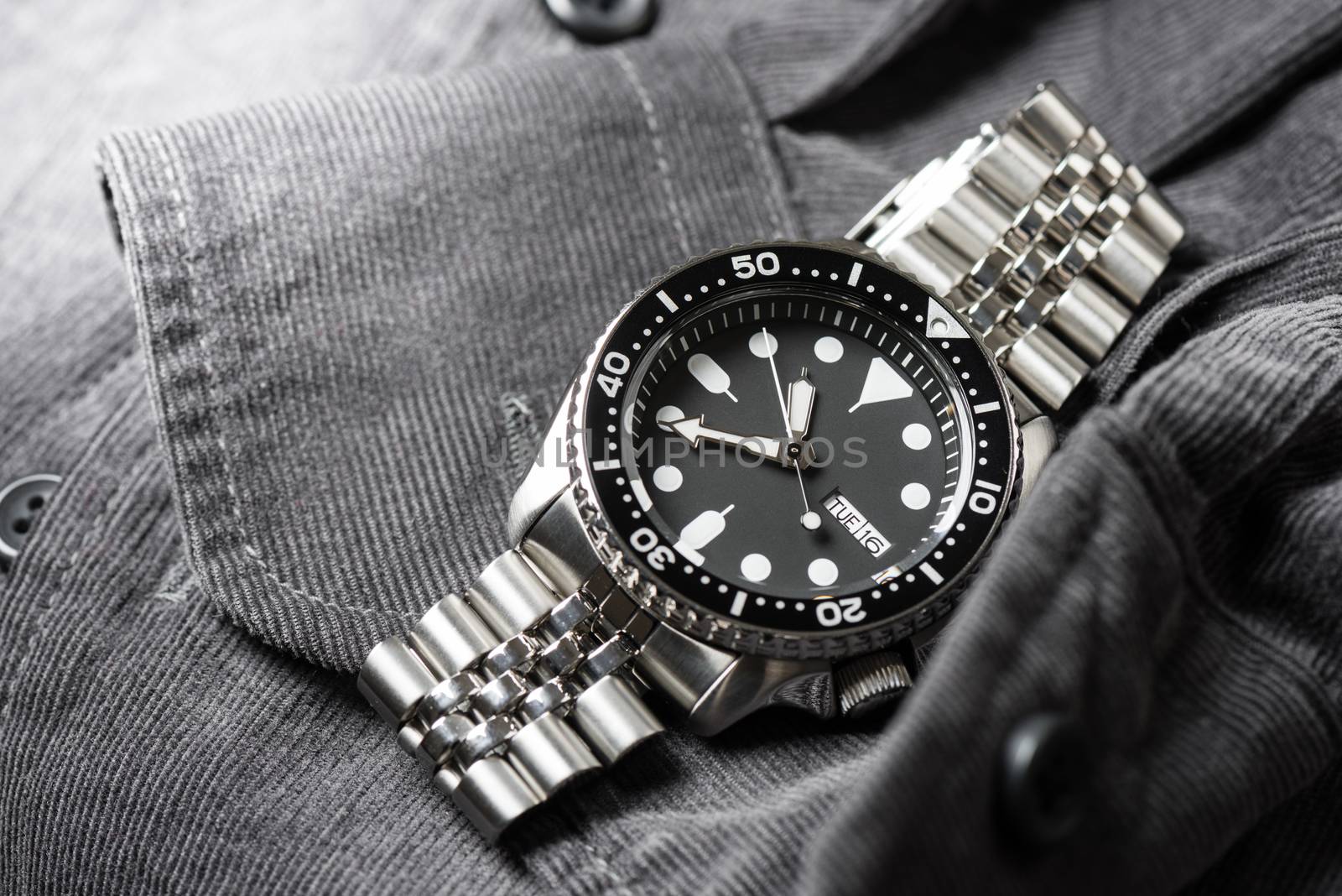 Close up men dive watch with stainless steel bracelet, luxury wristwatch for men.