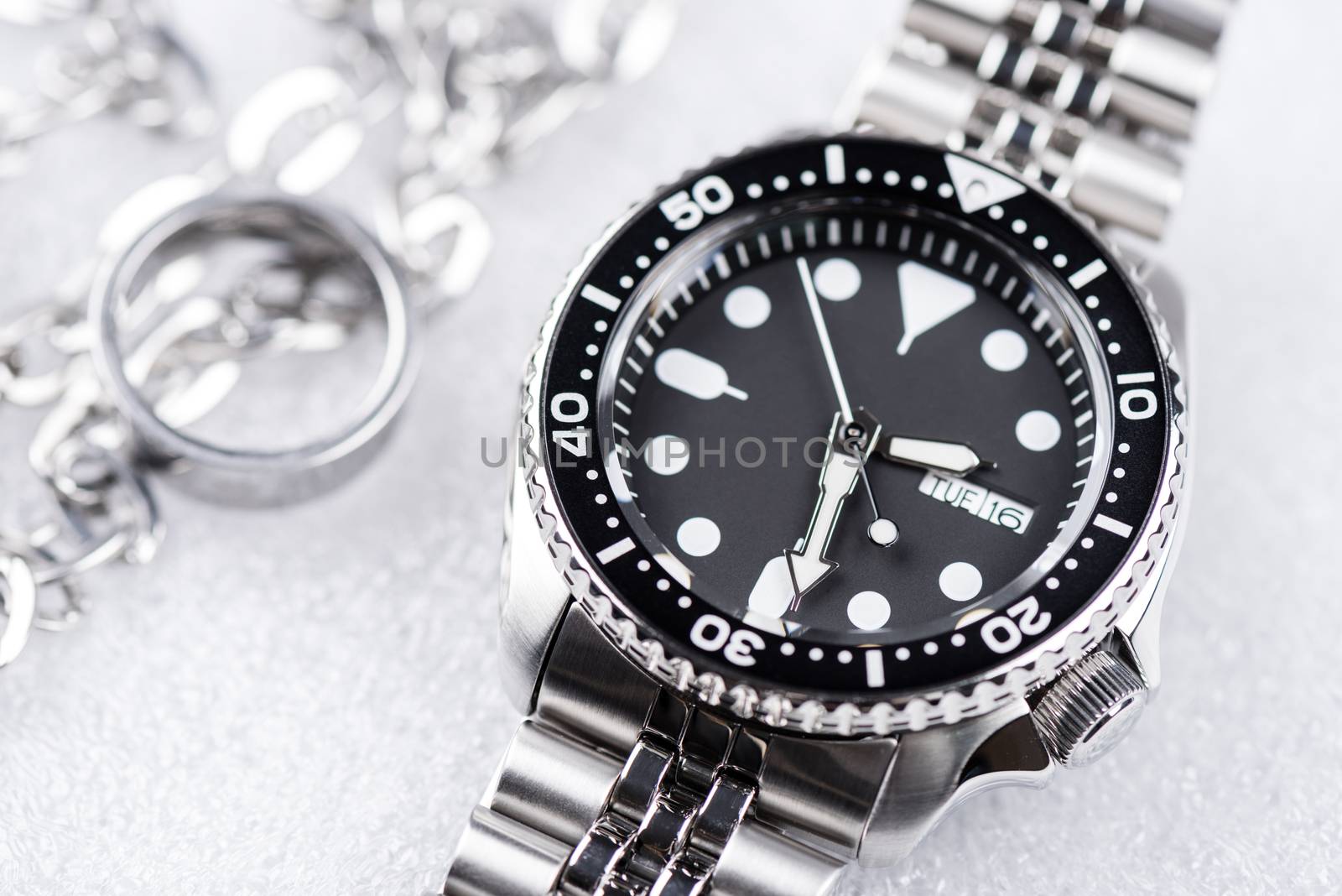 Close up men dive watch with stainless steel bracelet, luxury wristwatch for men.