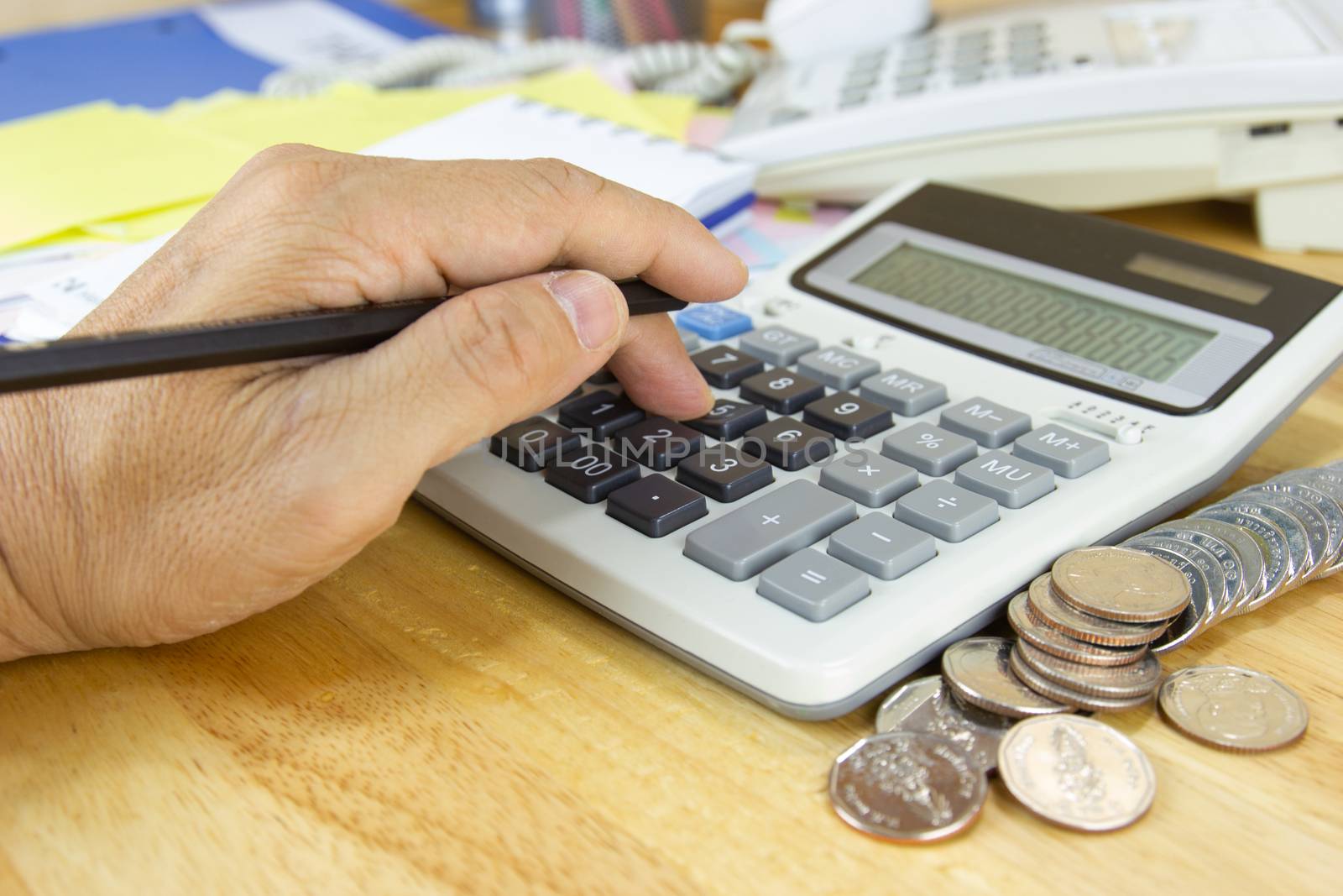 businessman use a calculator to calculate income and expenses in the office concepts, accounting, finance, investment