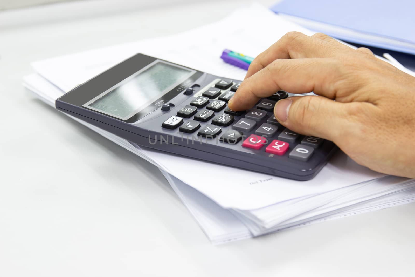 Employees use office calculators with documents of income, expenses, concept of life at work.