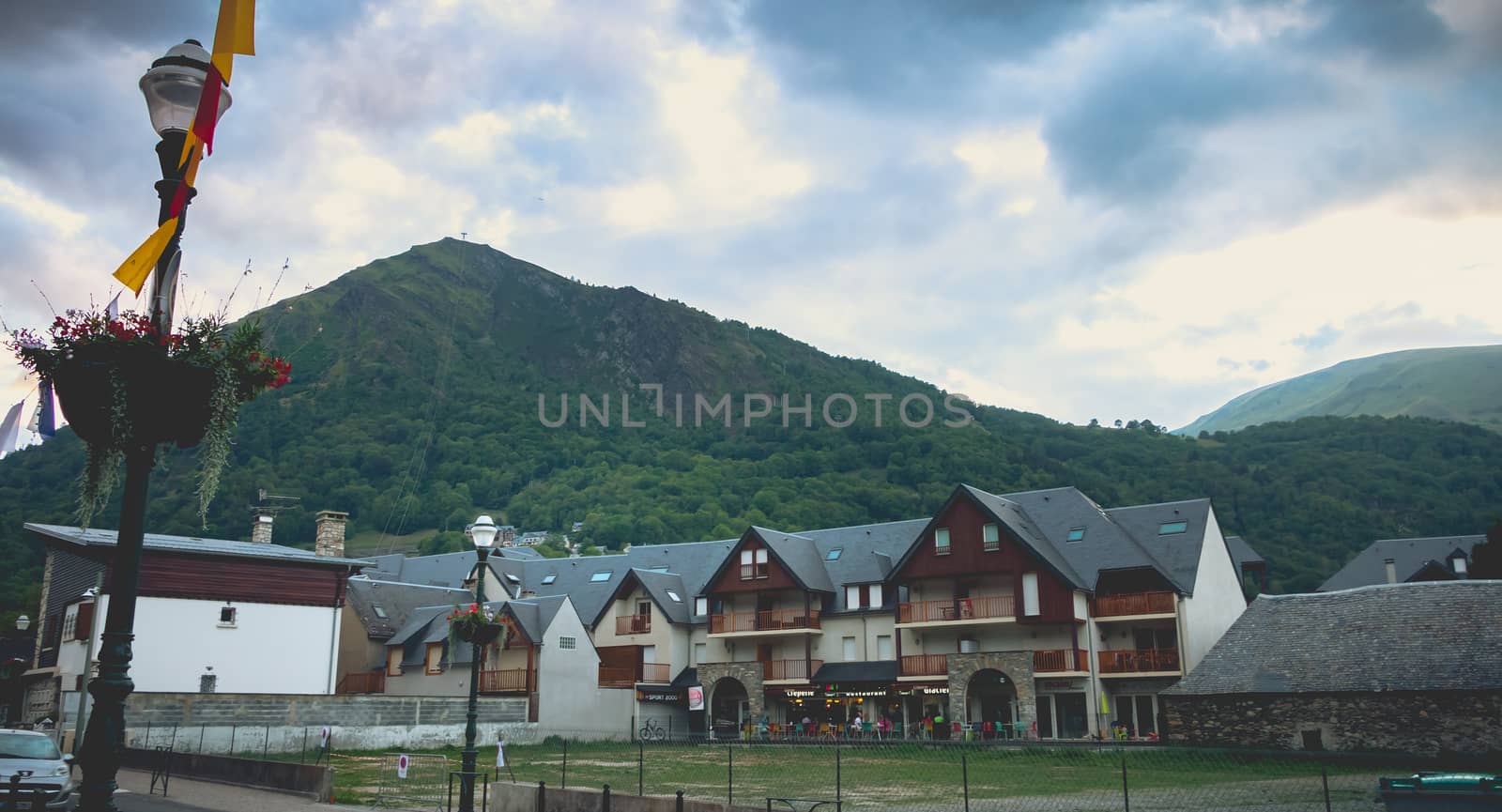Saint-Lary-Soulan, France - August 20, 2018: atmosphere and architecture in the city center where people go for a walk on a summer day