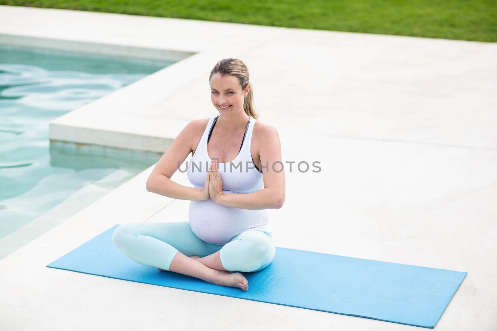 Pregnant woman doing yoga by Wavebreakmedia