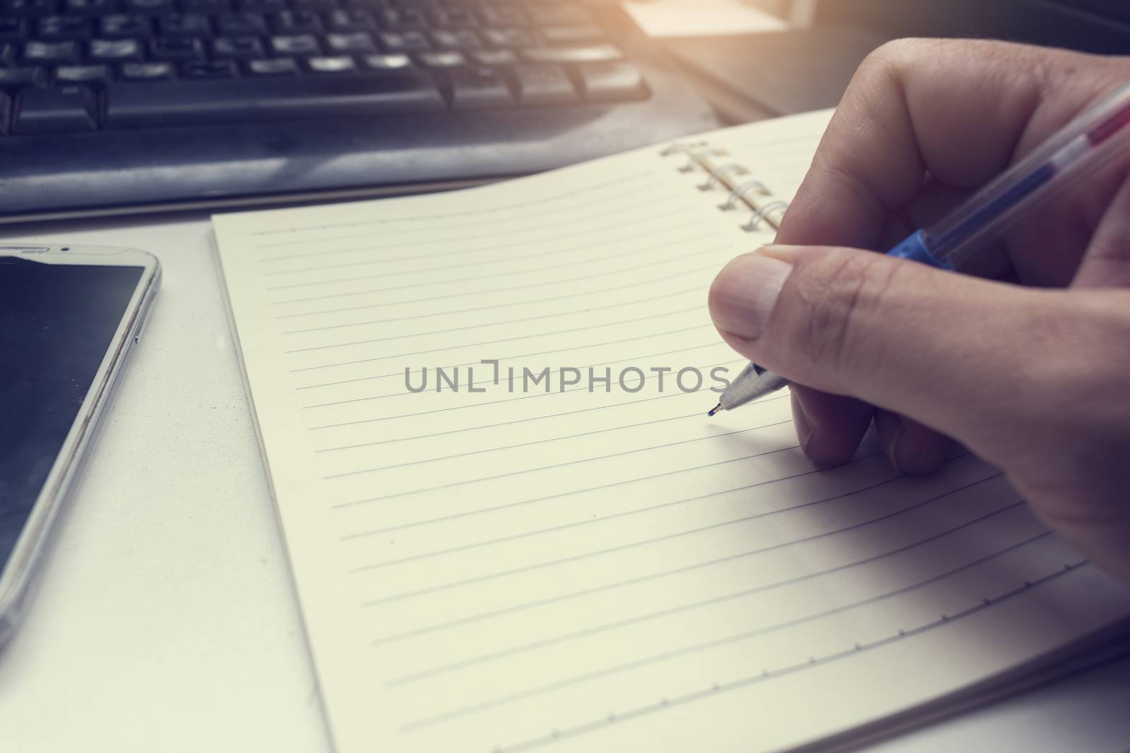 male hand writing in notebook with pen,right hand